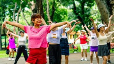 Group of women exercising together in a park.