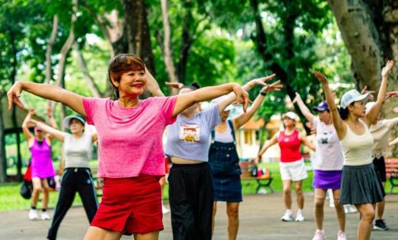 Group of women exercising together in a park.